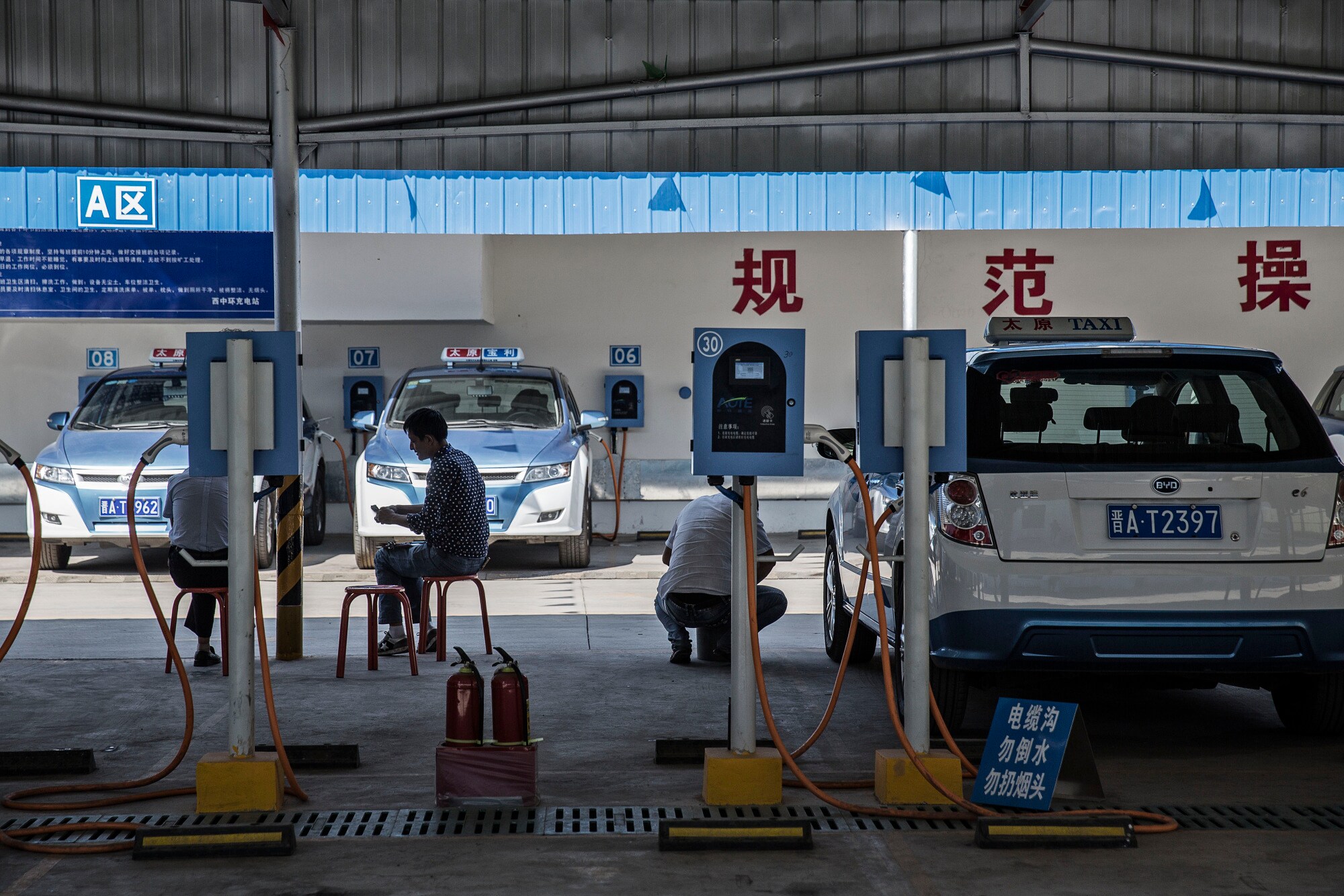 Electric taxis at a charging station in Taiyuan, Shanxi province.Photographer: Qilai Shen/Bloomberg