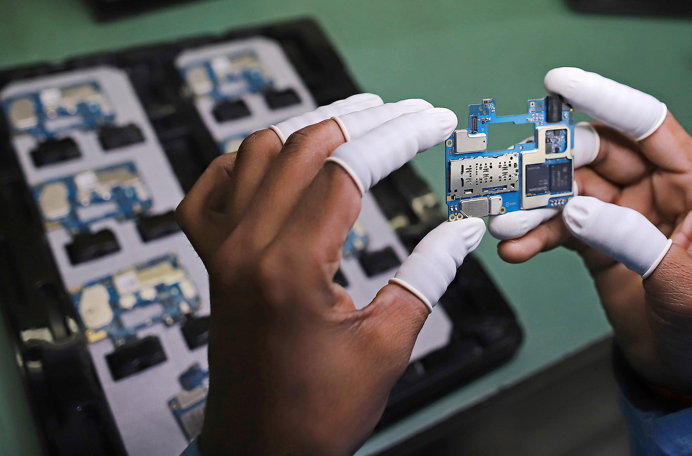 A phone's circuit board at the Dixon Technologies plant.Photographer: Anindito Mukherjee/Bloomberg
