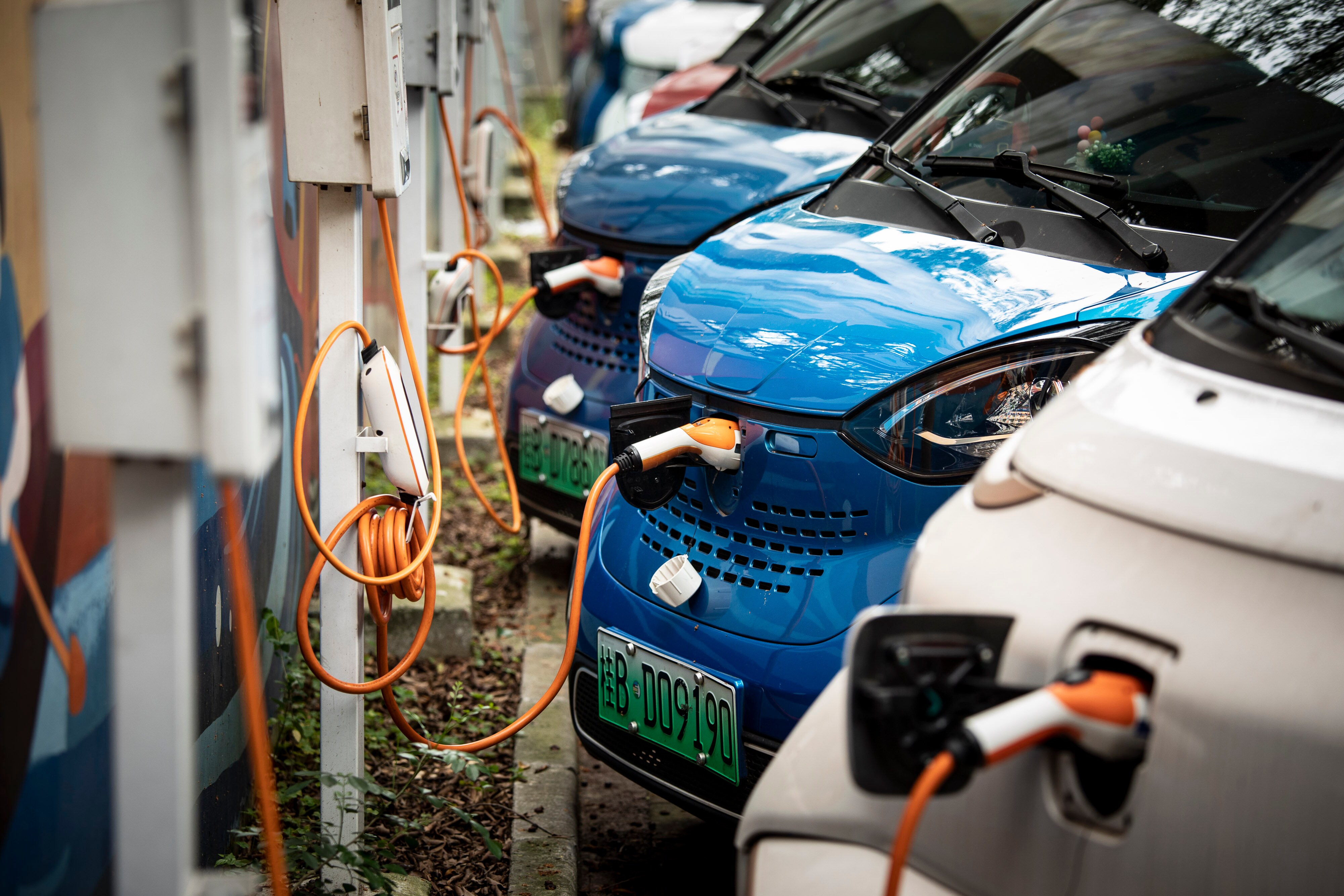 Electric vehicles charging in a parking lot in Liuzhou.Photographer: Qilai Shen/Bloomberg