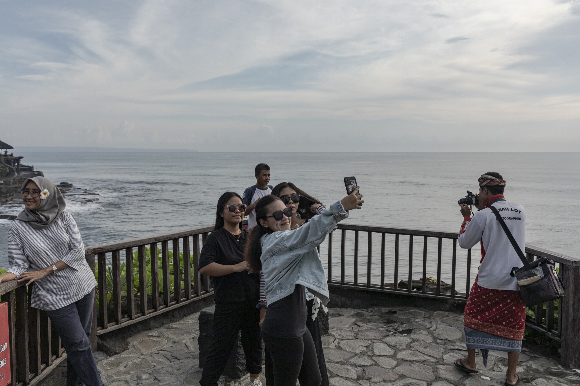 Taking selfies at Bali's Tanah Lot.Photographer: Nyimas Laula/Bloomberg