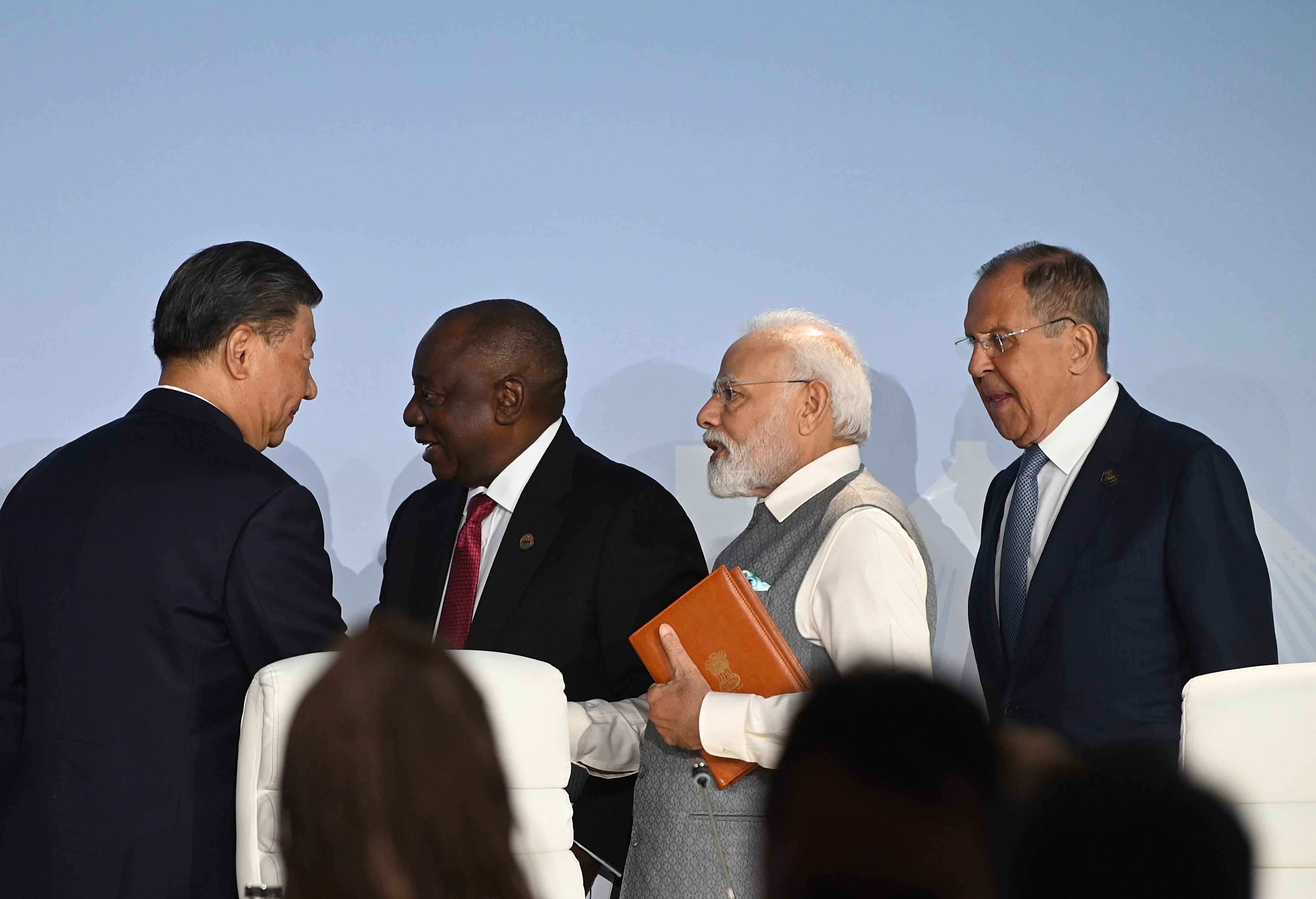 Xi Jinping, left, with Narendra Modi, second right, at the BRICS summit in South Africa Aug. 24.Photographer: Leon Sadiki/Bloomberg