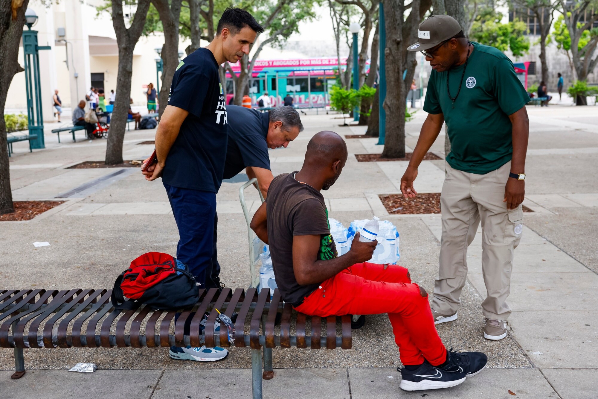 Miami-Dade County Homeless Trust representatives distribute bottles of water and shelter information during the city's recent heat wave.Photographer: Eva Marie Uzcategui/Bloomberg