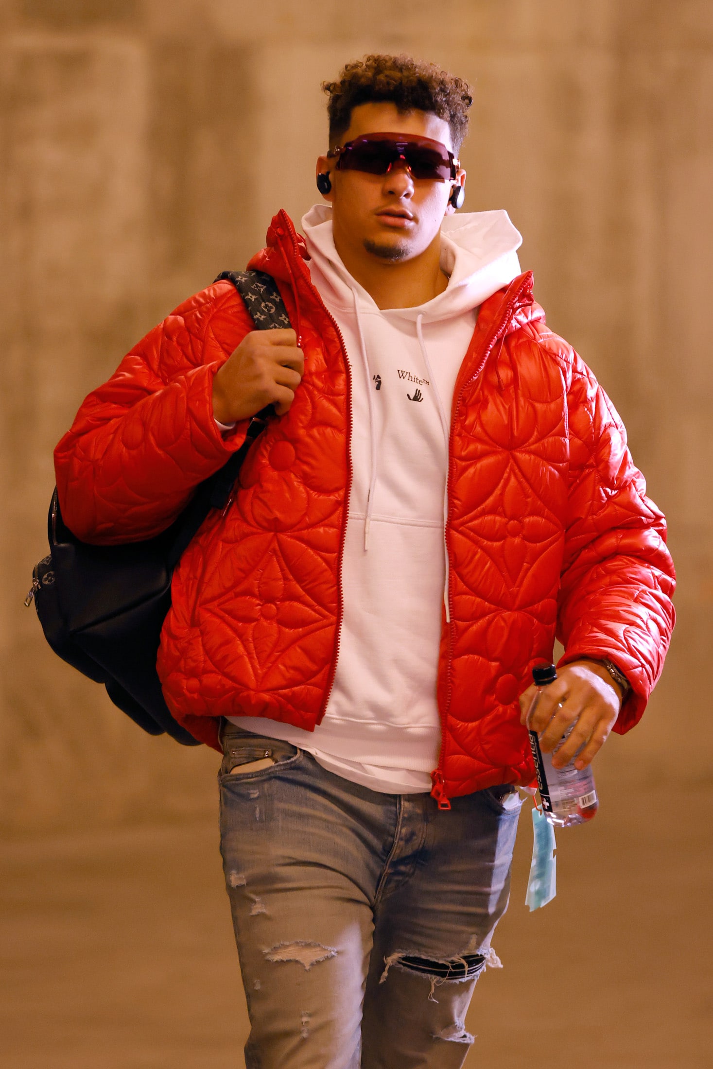 Kansas City Chiefs Quarterback Patrick Mahomes walks to the locker room in a Louis Vuitton jacket before the start of the AFC Championship Game against the Cincinnati Bengals on Jan. 30, 2022.Photographer: David Eulitt/Getty Images North America