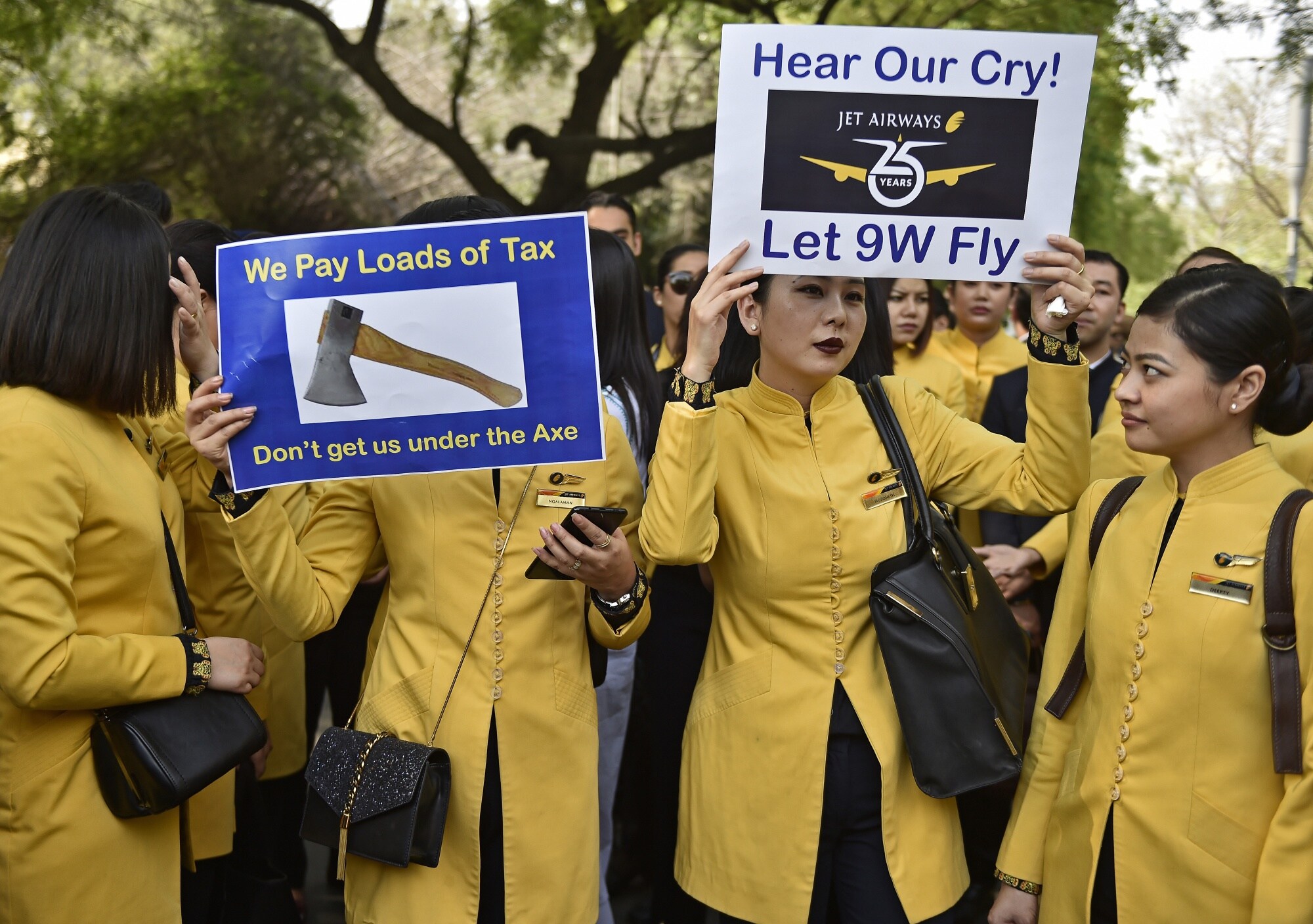 Jet Airways' cabin crew hold placards during a protest organized by the company's employees in Delhi in 2019. Photographer: Anindito Mukherjee/Bloomberg