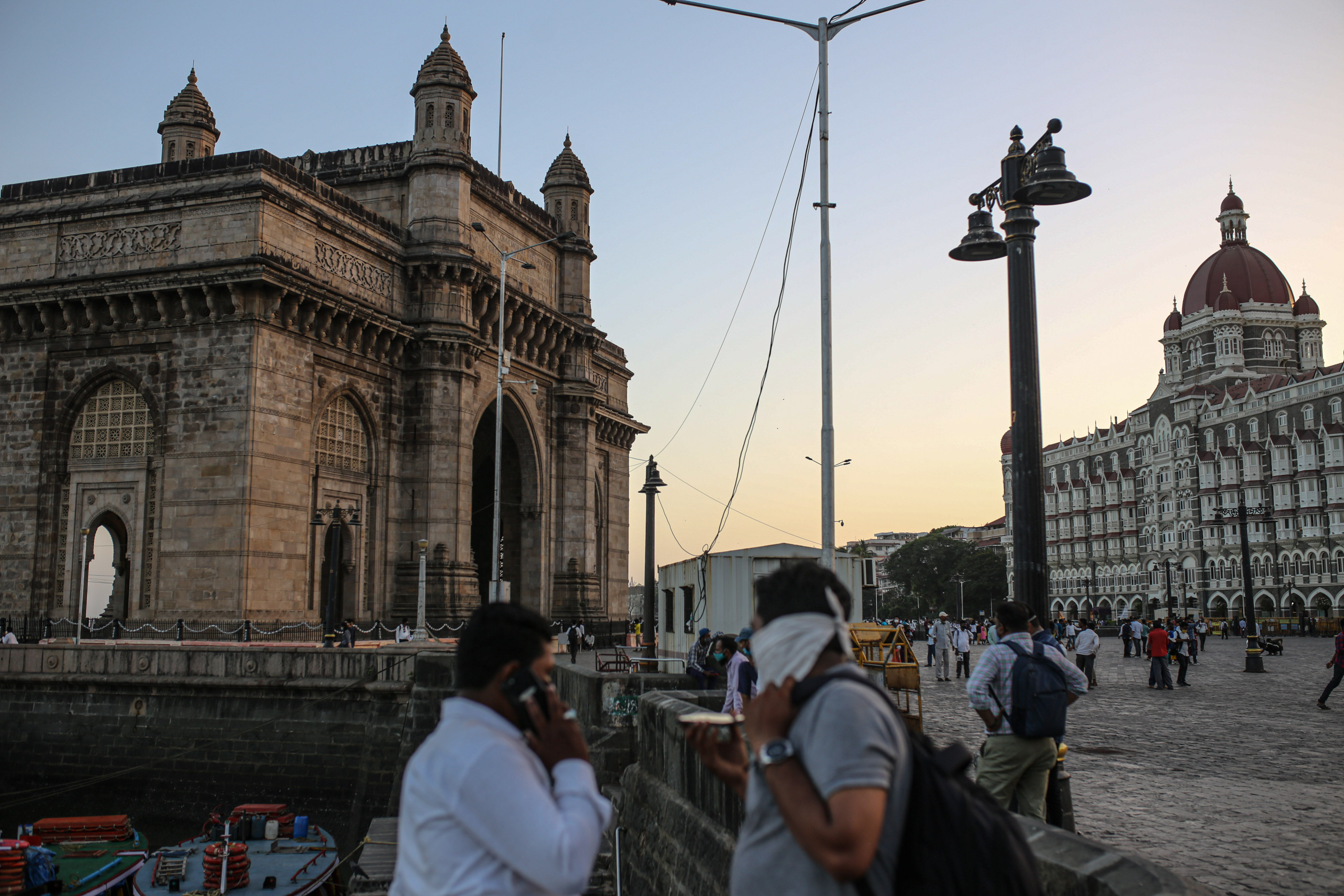 Pedestrians walk past the Gateway of India monument in Mumbai.Photographer: Dhiraj Singh/Bloomberg