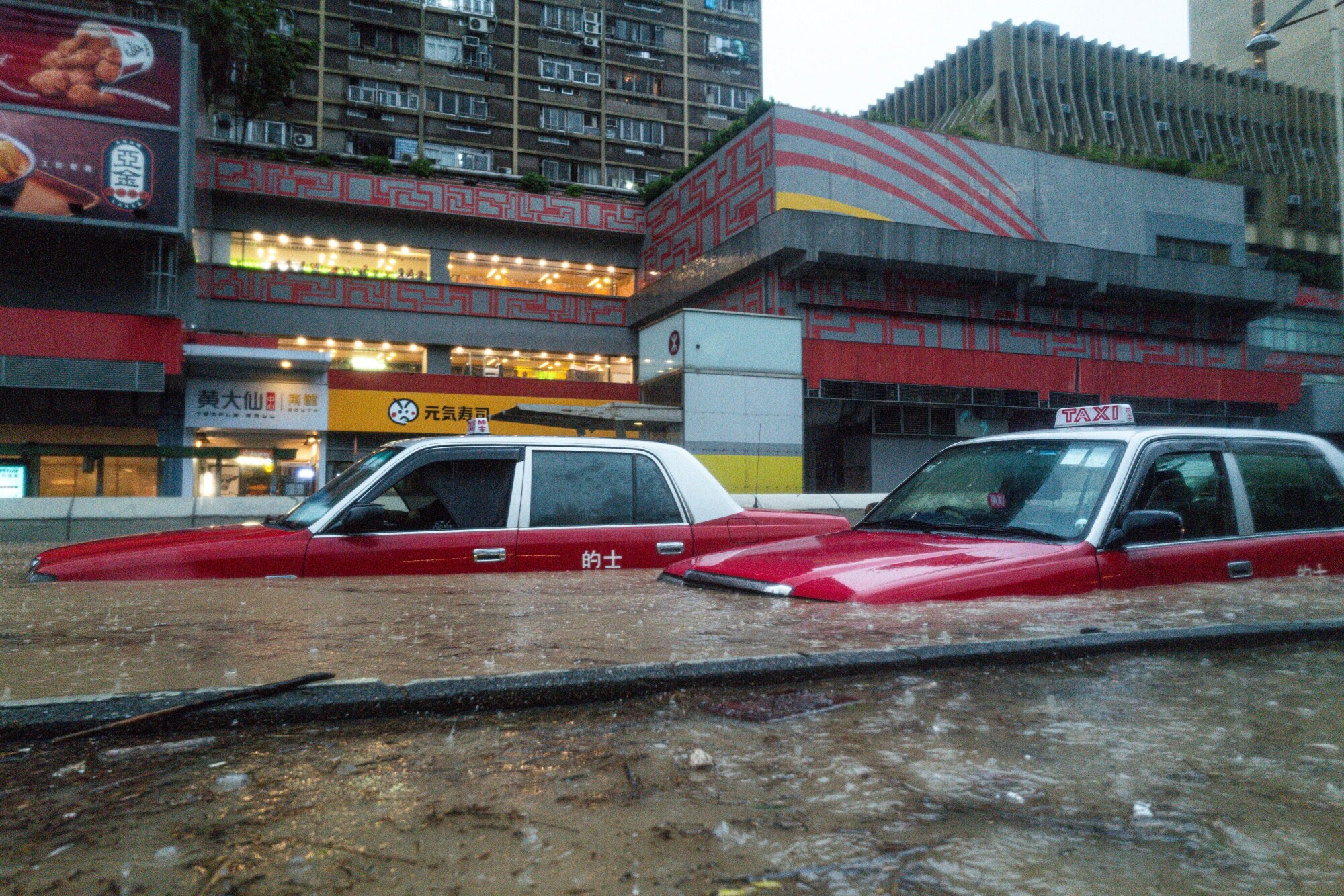 Taxis stranded in floodwaters in Hong Kong.Photographer: Lam Yik/Bloomberg