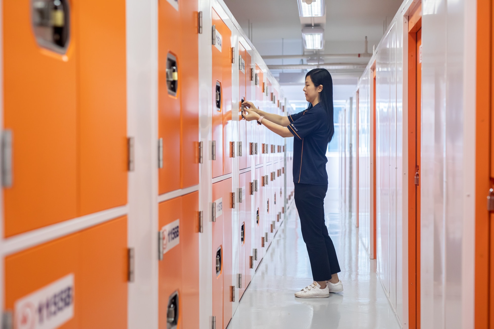 A worker shows the interior facilities of StorHub.Photographer: Paul Yeung/Bloomberg