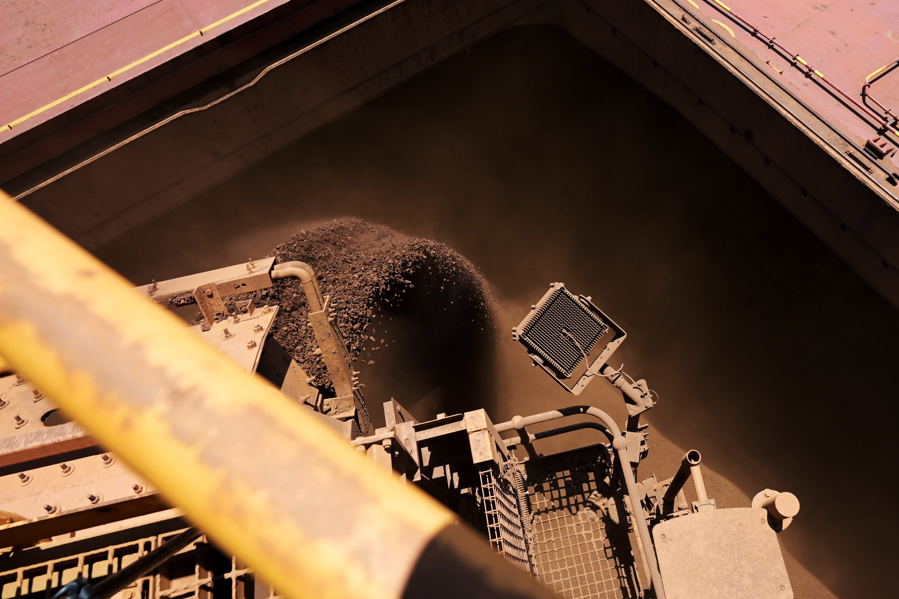 Iron ore is loaded onto a cargo ship at Parker Point port.Photographer: Carla Gottgens/Bloomberg
