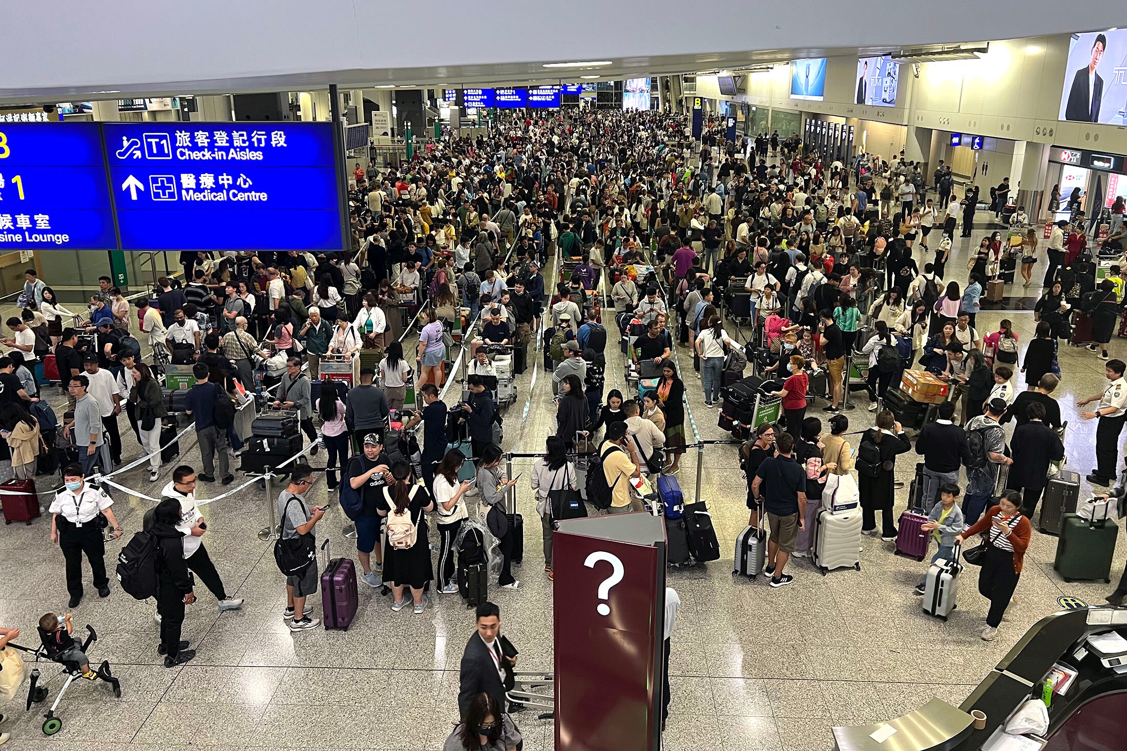 Travelers stranded at Hong Kong International Airport on Oct. 8.Source: Bloomberg