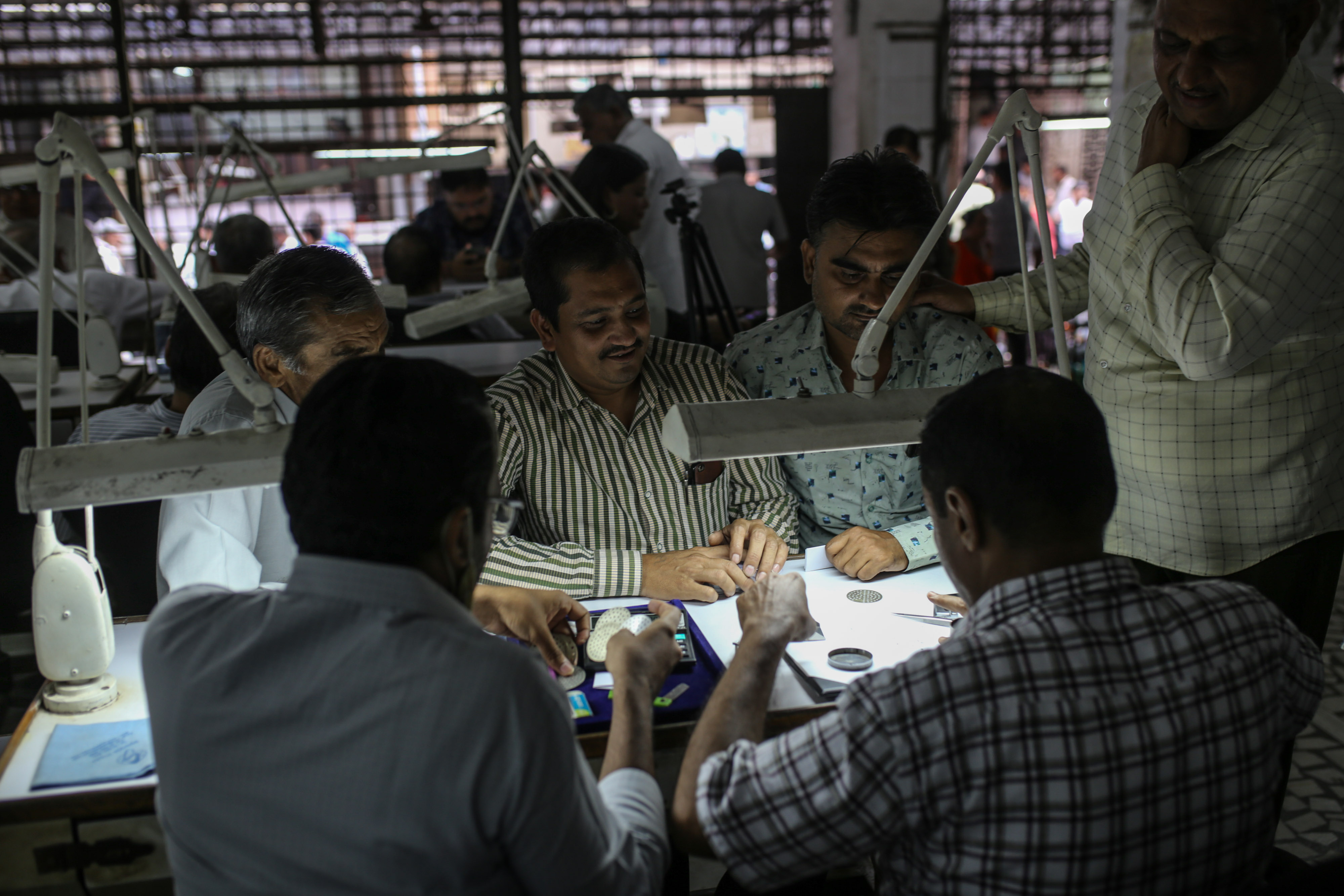 Traders inspect diamonds at a diamond market in Surat, Gujarat, India.Photographer: Dhiraj Singh/Bloomberg