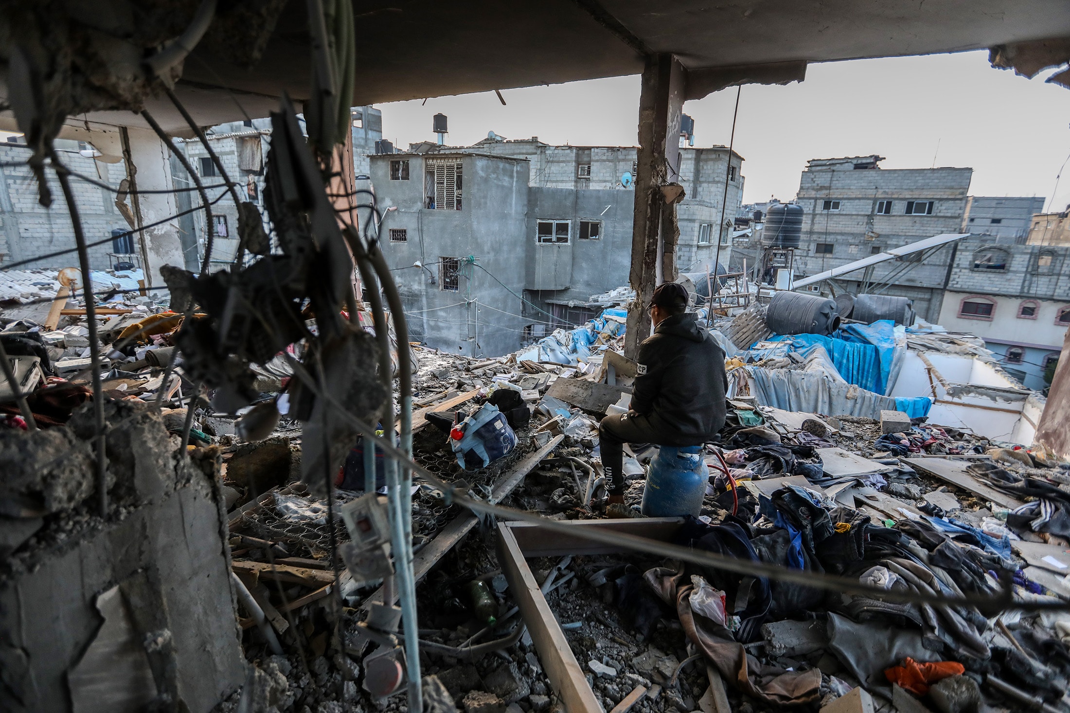A Palestinian resident inspects the destruction of their home following an airstrike in Khan Younis, southern Gaza, on Dec. 3.Photographer: Ahmad Hasaballah/Getty Images