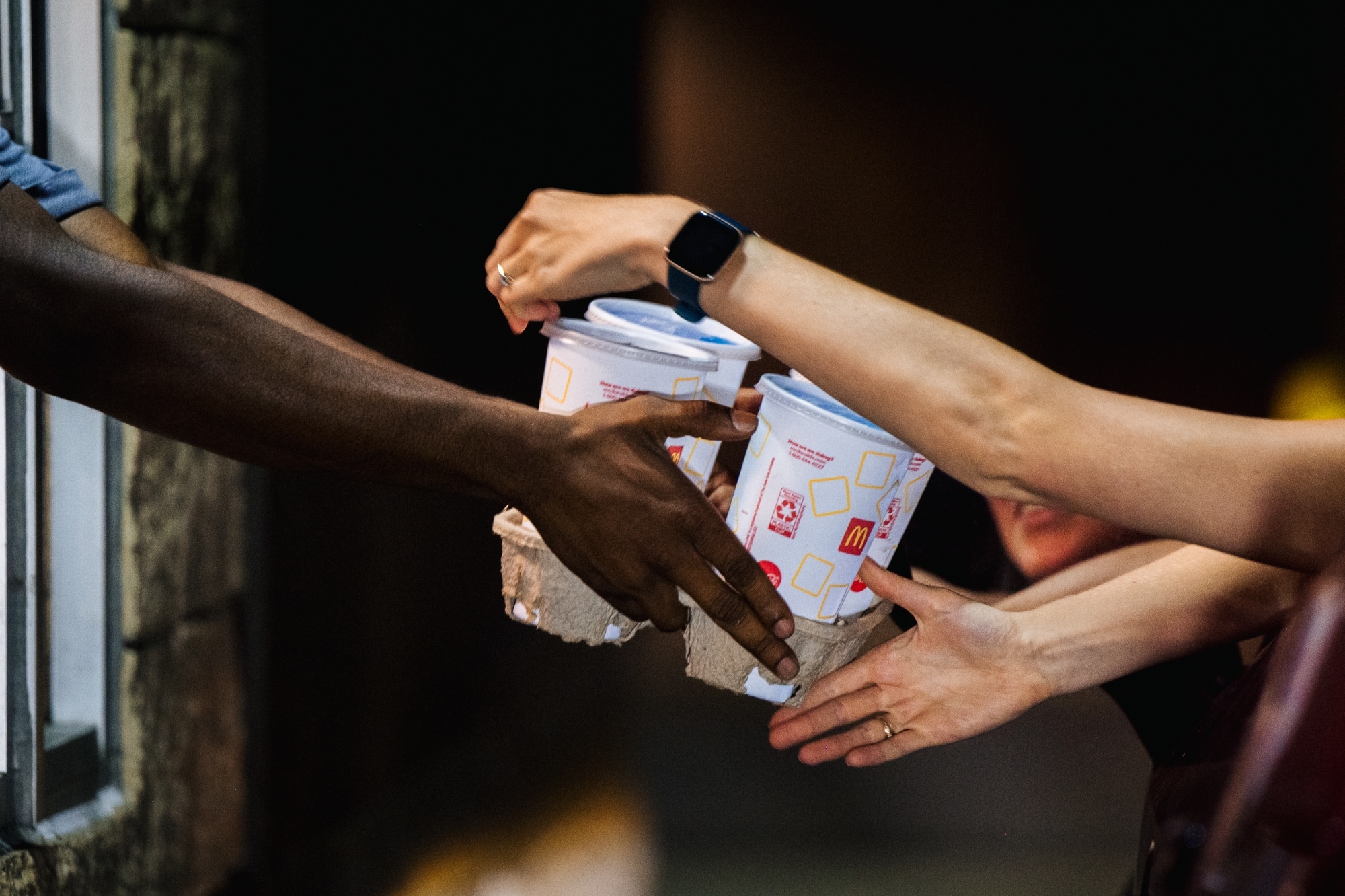 A McDonald's employee hands a customer her food in a McDonald's drive-thru in Houston, Texas. Photographer: Brandon Bell/Getty Images