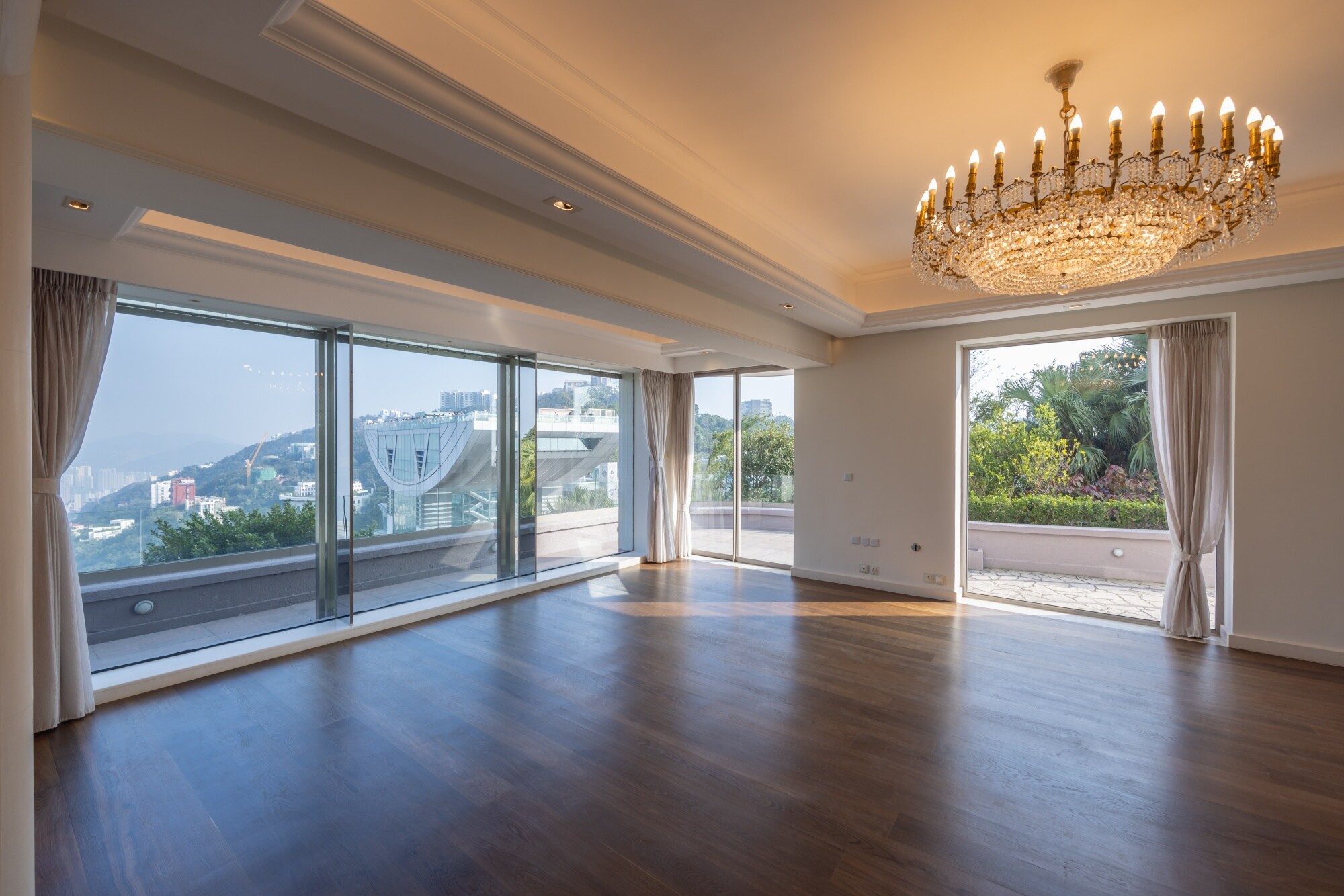 The living room opens up on to the garden and has views across Hong Kong island.Photographer: Paul Yeung/Bloomberg