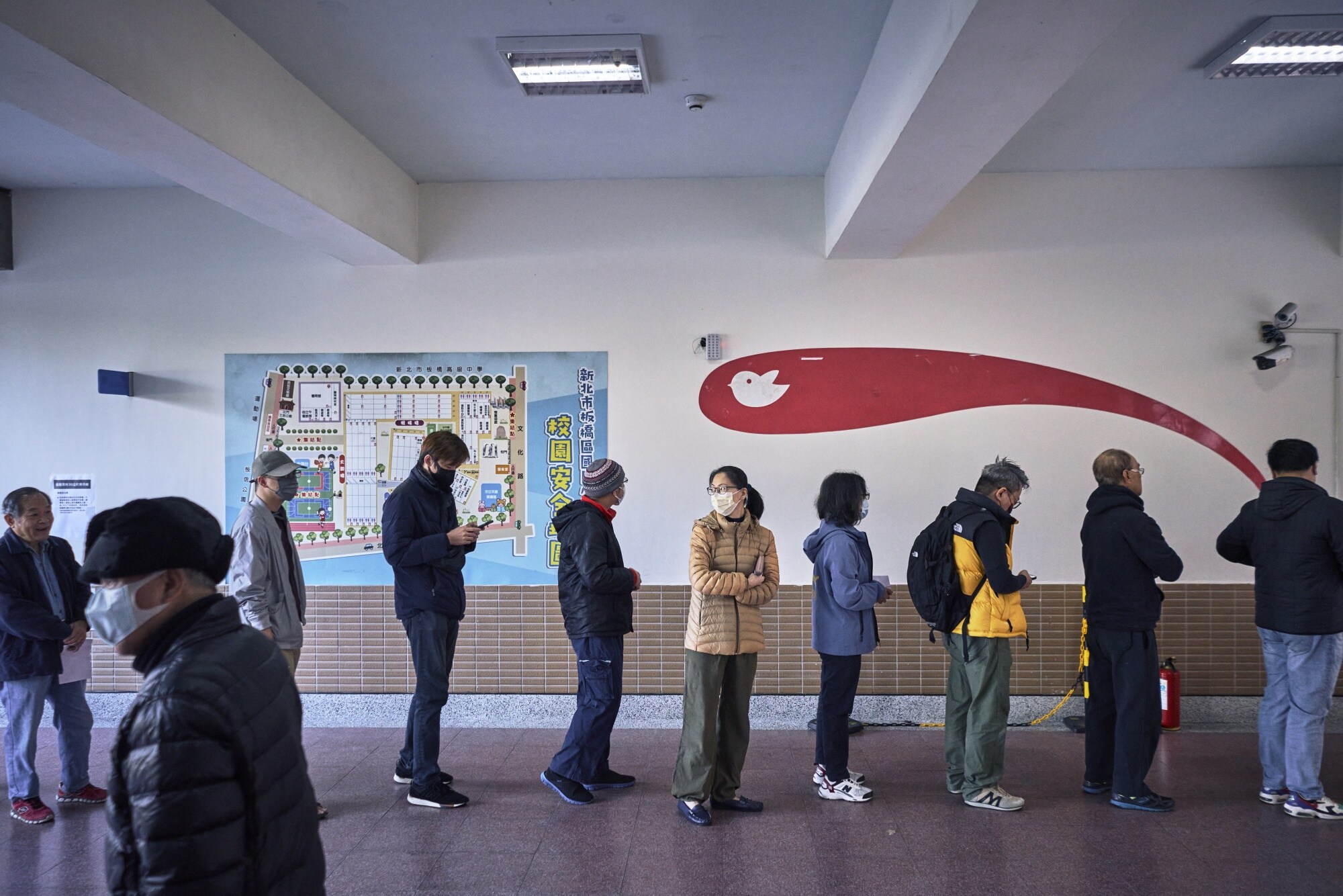 Voters stand in line at a polling station in Banqiao, New Taipei, on Jan. 13. Photographer: An Rong Xu/Bloomberg