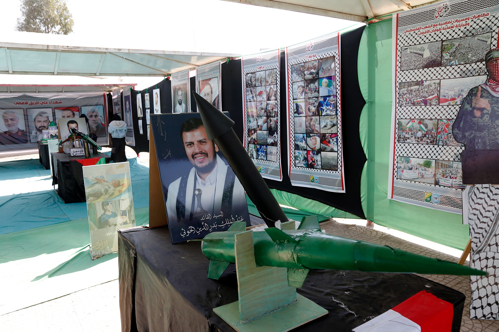 Mock missiles by an image of Yemen's Houthi leader Abdul-Malik Al-Houthi at an exhibition in solidarity with Palestinians, in Sana'a, Yemen, on Jan. 3. Photographer: Mohammed Hamoud/Getty Images