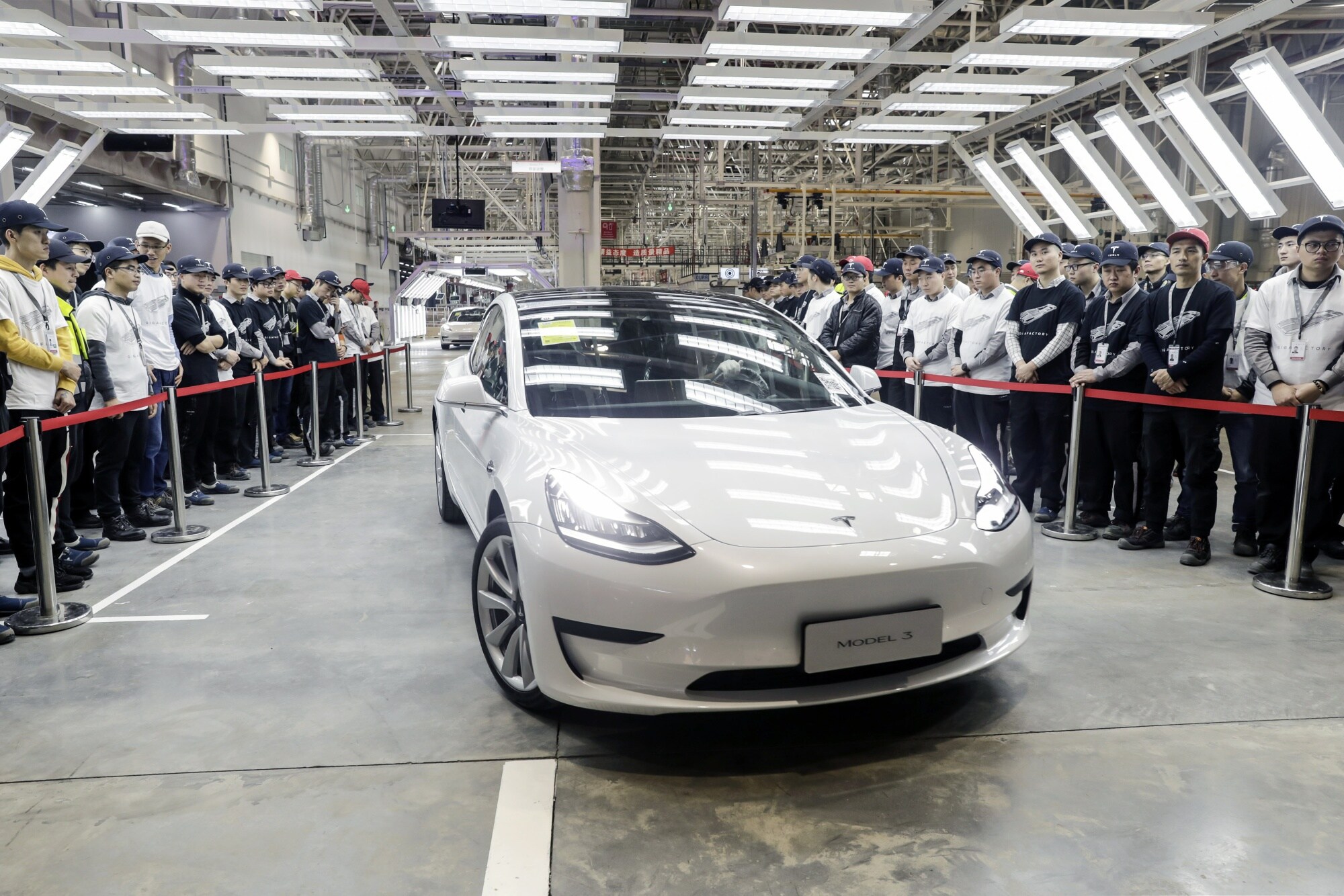 A Tesla Model 3 rolls off an assembly line at the company's Gigafactory in Shanghai in 2019. Photographer: Qilai Shen/Bloomberg