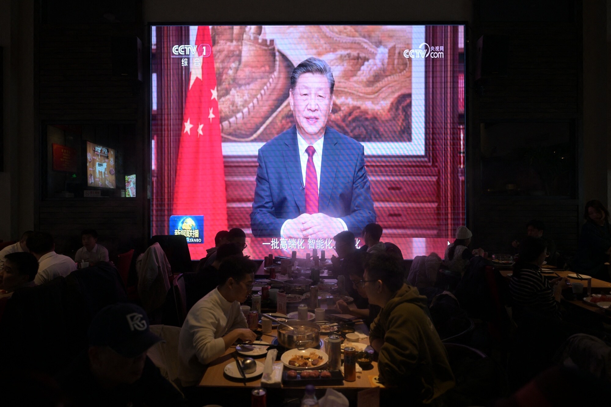 Xi Jinping's New Year's speech broadcast at a restaurant in Beijing on Dec. 31.Photographer: Pedro Pardo/AFP/Getty Images