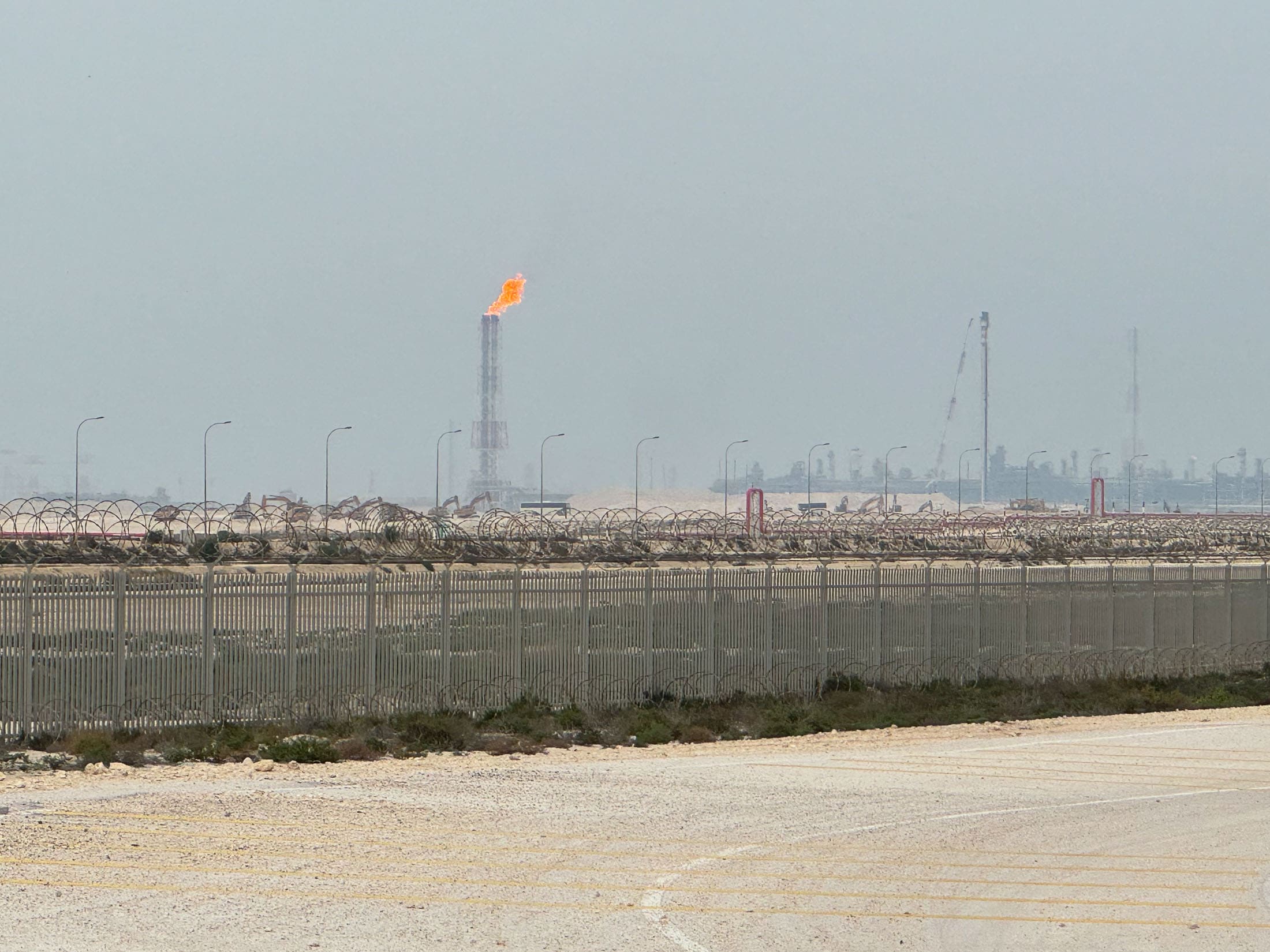 QatarEnergy's LNG site is ringed by barbed-wire-topped chain link fences.Photographer: Anthony Di Paola/Bloomberg
