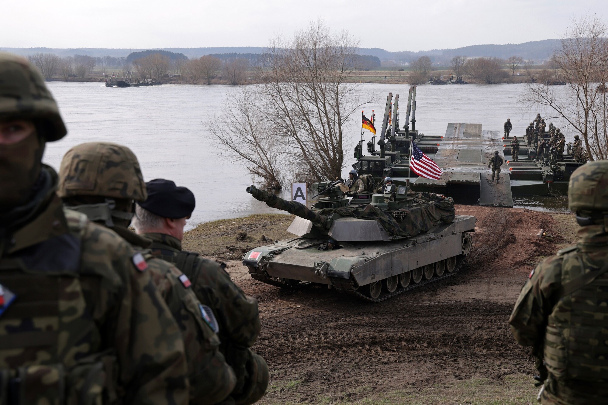 A US Army M1 Abrams main battle tank rolls off an amphibious rig on the Vistula River during the NATO Dragon 24 military exercise in Gniew, Poland, in March.Photographer: Sean Gallup/Getty
